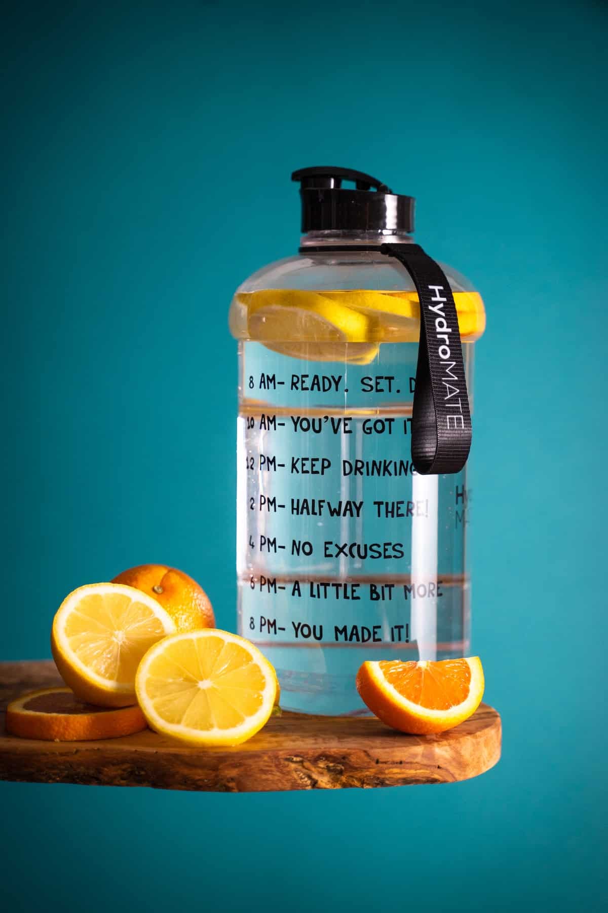 bottle of water with lemons and oranges