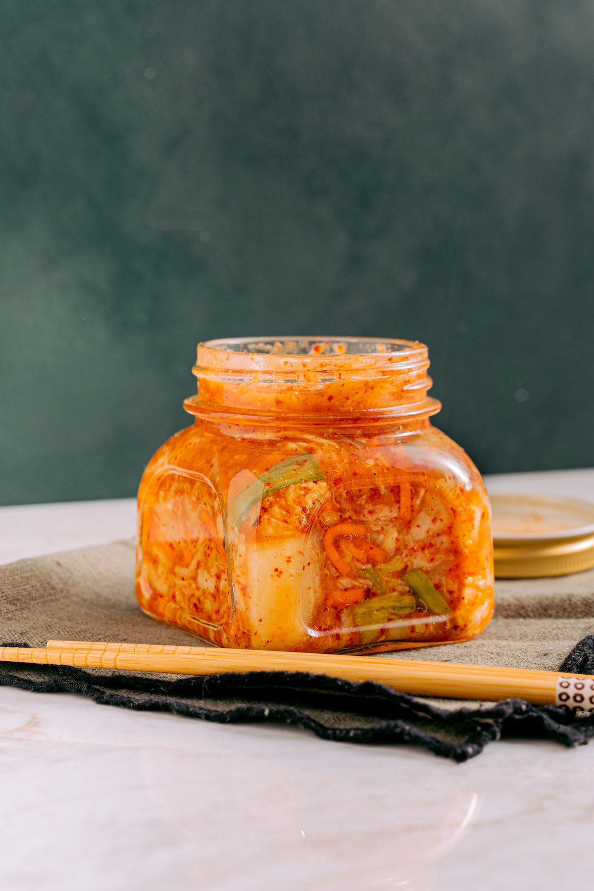 kimchi in a jar with chopsticks
